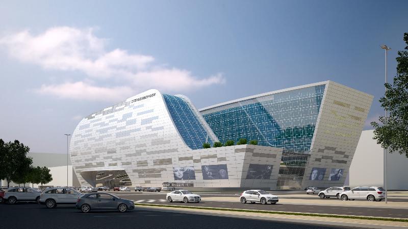 Steigenberger Hotel Доха Екстер'єр фото The image shows a modern architectural building with a futuristic design. The structure features large glass windows and a dynamic, flowing shape, combining different materials like metal and stone. There are green areas on the roof, and several scre